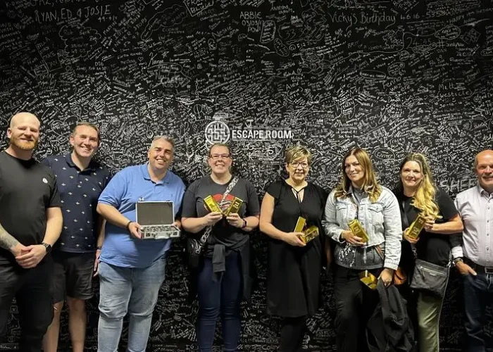 Corporate team celebrating after escaping an escape room during a team building event in Derby
