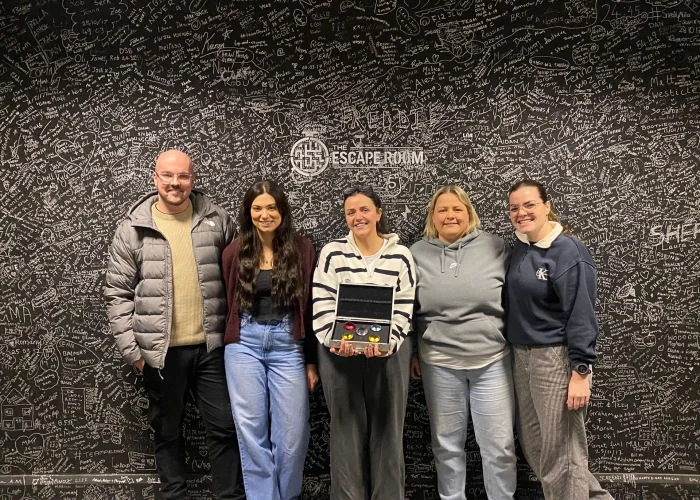 Team celebrating after escaping A Rough Trade escape room in Derby at The Escape Room Guys